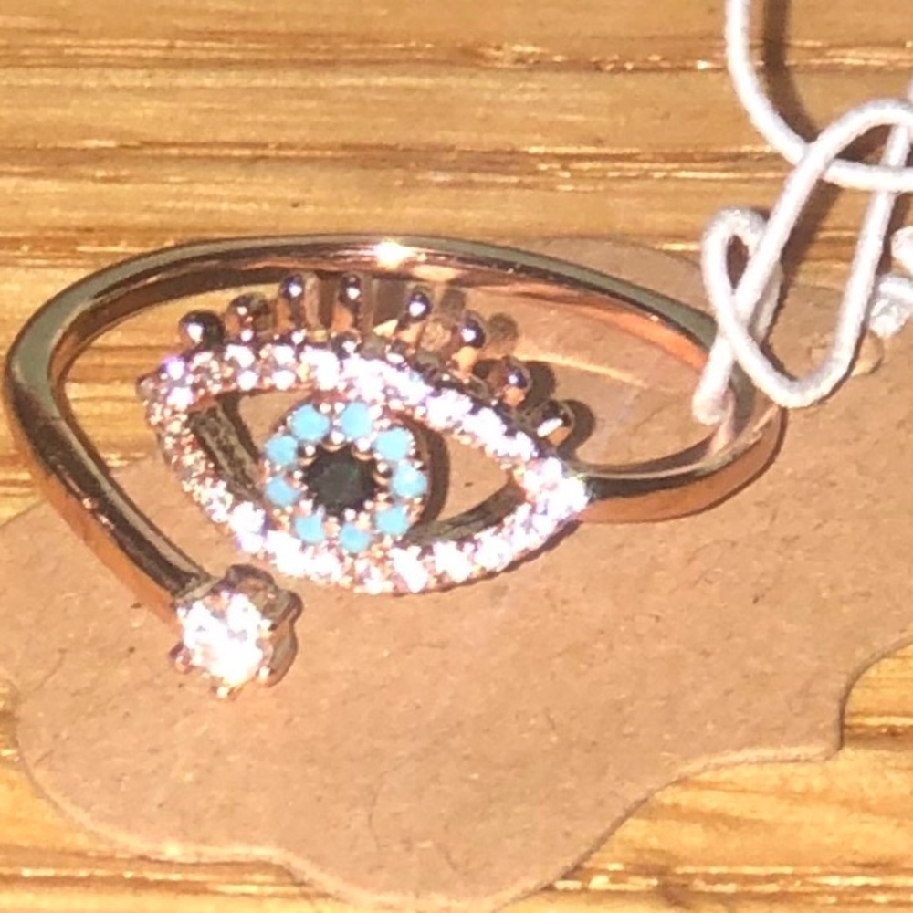 18k rose gold plated ring adjusts but fits size 7